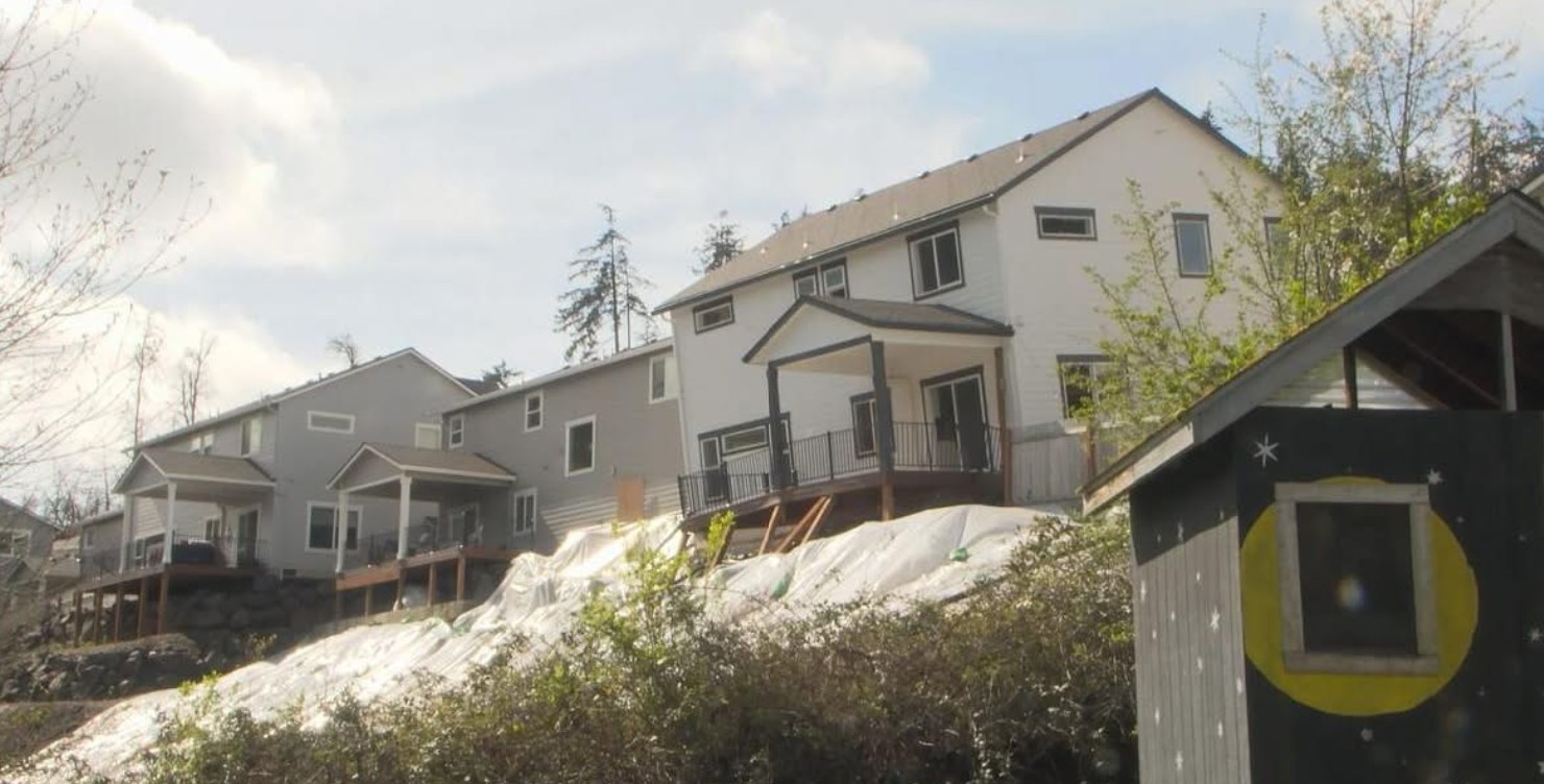 Three new houses in Laurel Hill Valley sliding down hillside. Middle one had to be demolished.